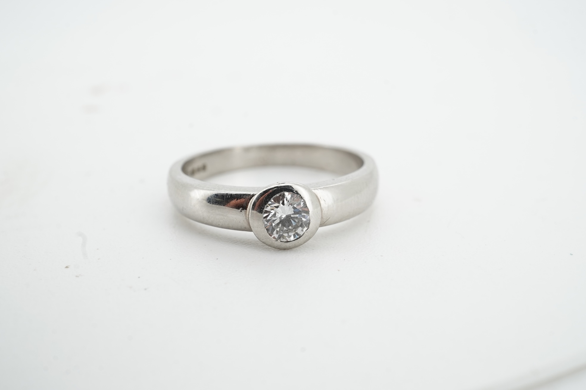A diamond ring, collet-set with a brilliant-cut diamond weighing approximately 0.52 carats, mounted in platinum, size K1/2, British hallmarks, gross weight approximately 4 grams